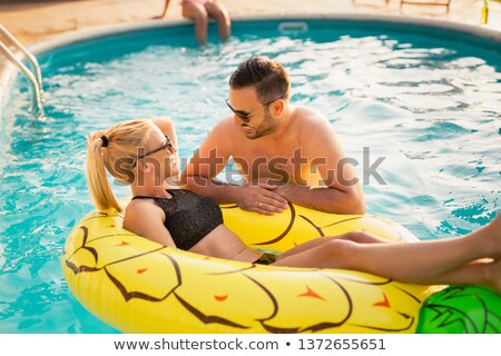 Foto d'archivio: Three Young Woman Floating On An Air Mattress