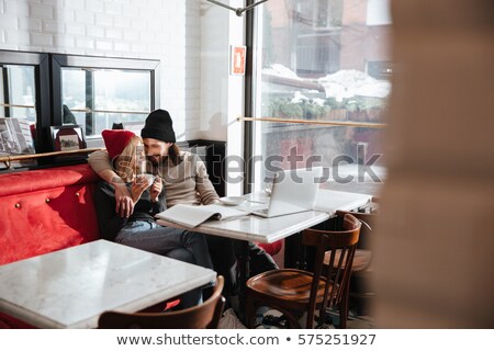 Zdjęcia stock: Side View Of Woman Hat By The Table With Journal