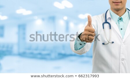 Stock foto: Smiling Cheerful Male Doctor With Stethoscope Showing Thumbs Up