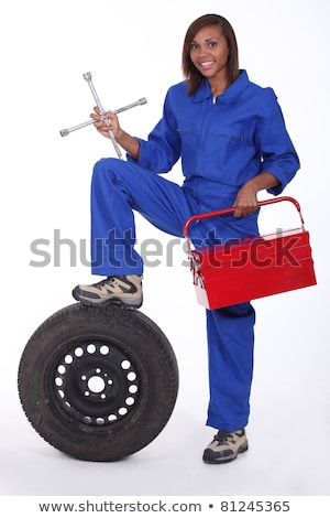 Сток-фото: Young African Mechanic With Tyre And Spanner