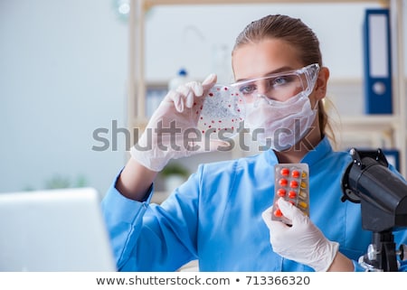 Foto stock: Female Scientist Researcher Conducting An Experiment In A Labora