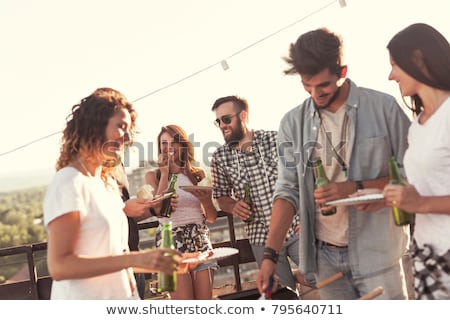Foto stock: Friends At Barbecue Party On Rooftop In Summer