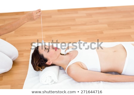 Foto stock: Woman Being Hypnotized With Pendulum