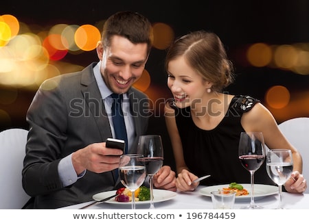 Stock fotó: Smiling Couple Eating Main Course At Restaurant