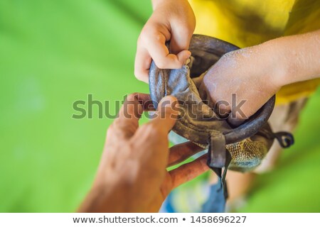 Foto stock: Climber Holds Magnesium Powder Chalk Bag In Hands And Lubricates Hands Before Starting Training