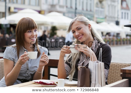 Stok fotoğraf: Beautiful Happy Woman Sitting On A Table With Espresso Coffee