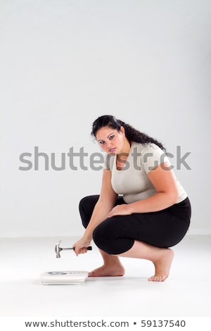 Сток-фото: Obese Woman Looking Angry At Scale