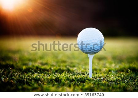 Foto stock: Golf Ball On Tee With Blue Sky