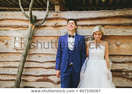 Сток-фото: Beautiful Young Wedding Couple Stands Near House