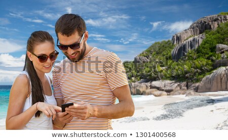 Stok fotoğraf: Happy Couple With Smartphone On Seychelles Island