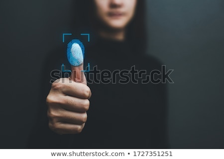 Foto d'archivio: Woman Accessing Hologram With Fingerprint