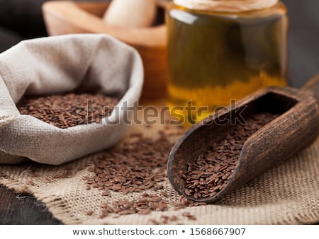 Сток-фото: White Bowl Of Raw Natural Organic Linseed Flax Seed Oil Omega 3 Capsules On White Background