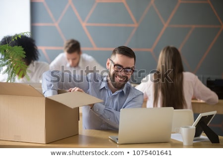 Foto d'archivio: Happy Male Office Worker With Personal Stuff