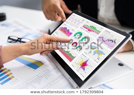 Foto stock: Financial Analyst Using Convertible Laptop Screen
