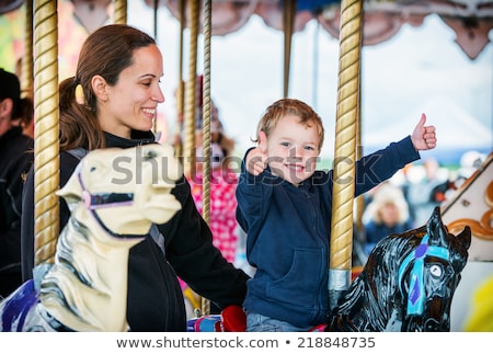 Foto d'archivio: Mother And Son On Carousel