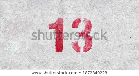 Foto stock: The Number 13 Sprayed With White Color On Stone
