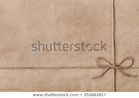 Foto d'archivio: String Bow On Brown Paper