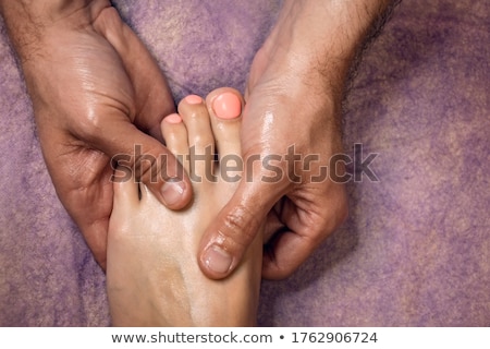 Stock photo: Man Massaging Womans Feet