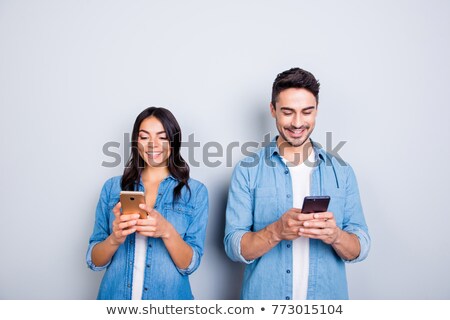 ストックフォト: Smiling Young Woman Sending An Sms