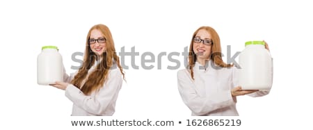 Foto d'archivio: Young Female Doctor Holding Jar Of Protein Isolated On White