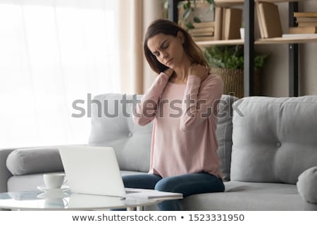 [[stock_photo]]: Unhappy Woman Suffering From Neck Pain At Home