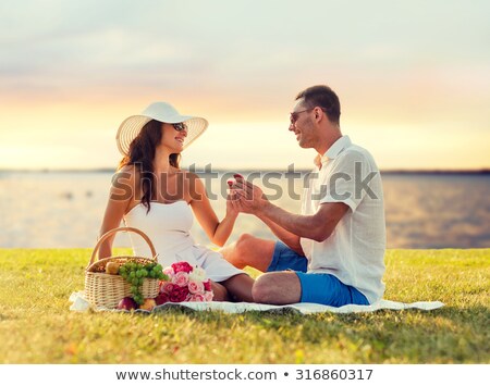 Stockfoto: Smiling Couple With Small Red Gift Box At Picnic