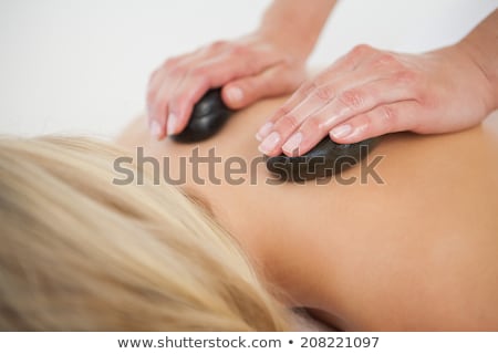 Foto d'archivio: Masseuse Massaging With Stone In Spa