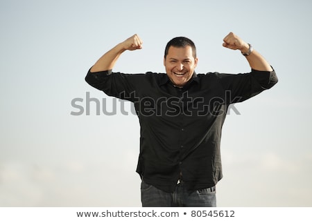 Foto d'archivio: Macho Bearded Man Flexing His Arms