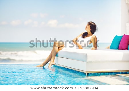 Foto d'archivio: Beautiful Women On A Bed In The Beach