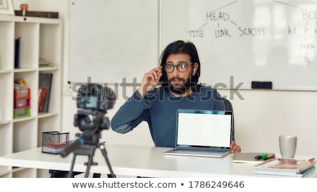 Stock fotó: Male Video Blogger Adjusting Camera At Home Office
