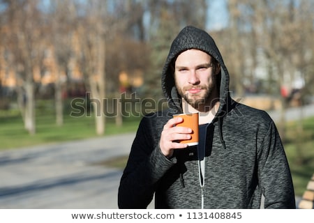 Stok fotoğraf: Hooded Man Jogging In The Park In Early Autumn Morning