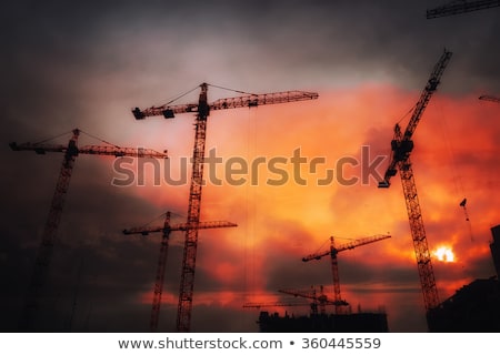 Foto stock: Industrial Background With Cranes Over Sunset Sky