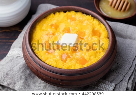 Stok fotoğraf: Millet Porridge With Pumpkin In A Clay Bowl On A Rustic Wooden Background