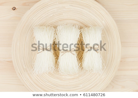 Stock photo: Sheaf Raw Asian Cellophane Noodles On Beige Wooden Board With Copy Space Top View