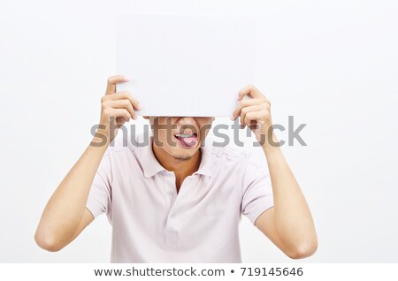 Stock foto: Asian Man Tongue Out Holding White Paper Card Covering Eyes