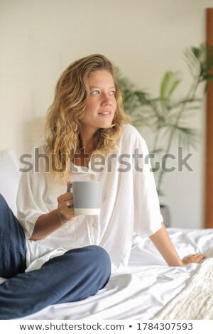 ストックフォト: Woman Looking Happy In Bed With Cup