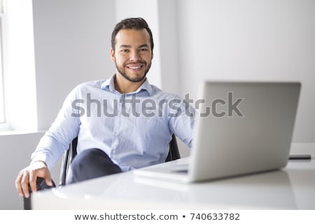 Imagine de stoc: Mexican Attractive Businessman On His 30s Working At Modern Home Office With Computer Laptop