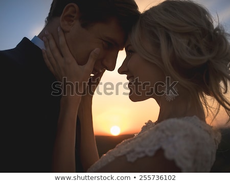 Bride And Groom Embrace On Field Stok fotoğraf © bezikus