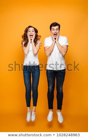Stock fotó: Screaming Young Cute Loving Couple Posing Isolated Over Yellow Background