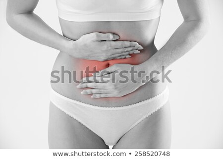 Foto d'archivio: Monochrome Shot Of Woman In Underwear Holding Stomach In Pain