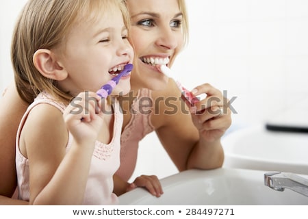 Zdjęcia stock: Child Brushing Teeth With Mother