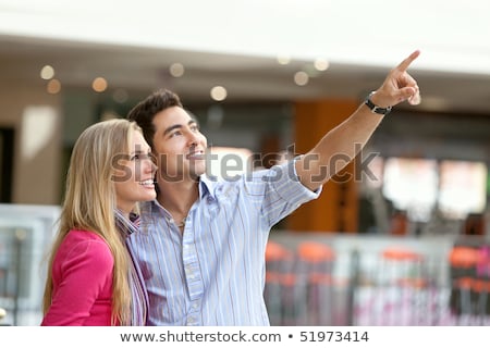 [[stock_photo]]: Happy Couple At A Shopping Center Smiling And Looking Something