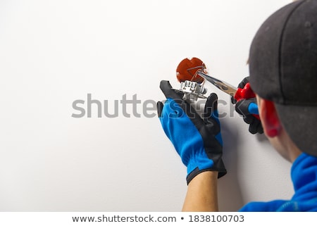 Foto stock: Electrician Installing An Electrical Outlet