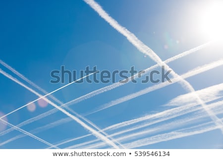 Foto stock: Blue Sky With Condensation Trail Of An Aircraft