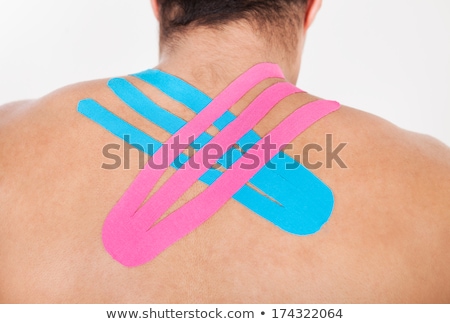 [[stock_photo]]: Rear View Of Man With Physio Tape
