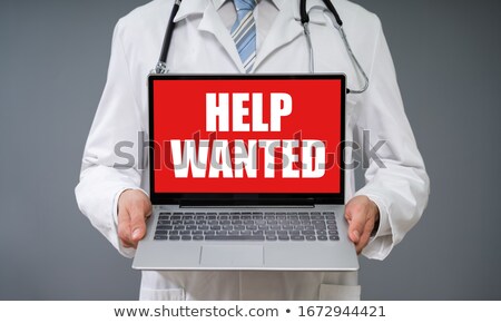 Stok fotoğraf: Doctor Holding Laptop With Help Wanted Screen