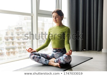 Stock foto: Photo Of Focused Young Woman Meditating While Doing Yoga Exercises