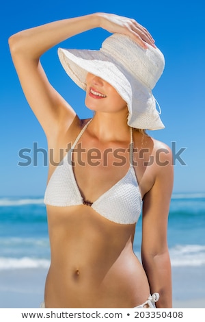 Foto stock: Beautiful Happy Blonde On The Beach In White Bikini And Sunhat