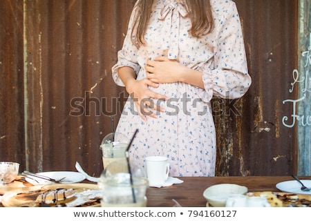 Stock photo: Woman Stomach Pain After The Sweet Cake