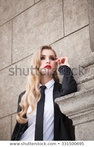 Stockfoto: A Woman In A Business Suit Long Hair And Red Lips